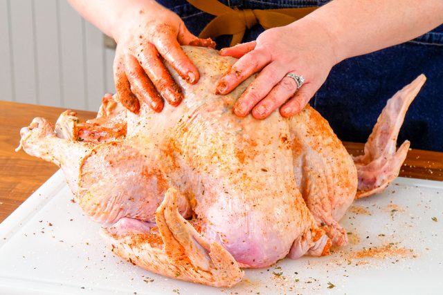 Marinating a Turkey on Cutting Board on Wooden Surface
