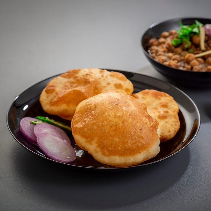choley bhature is a dish originated initially in the northern part of the Indian subcontinent. It is a combination of chana masala and bhatura, a fried bread made from maida.