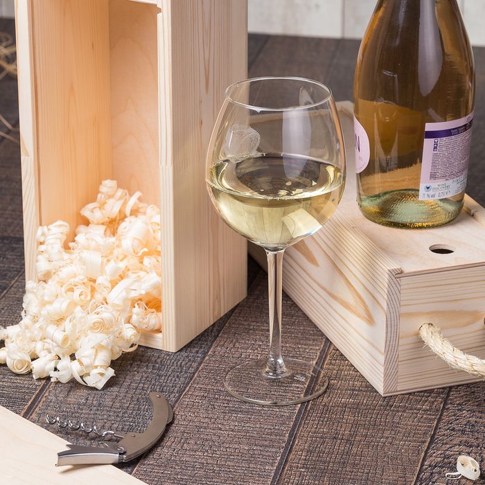 High Angle View Of White Wine With Sawdust In Box