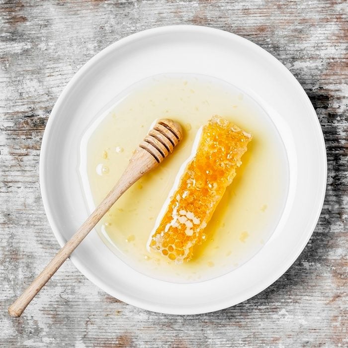 Honeycomb on a plate on wooden background