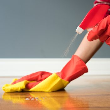 Cleaning parquet with yellow cloth