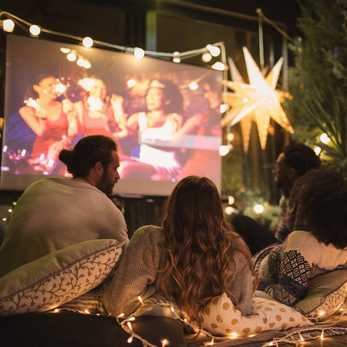 Friends making movie night at back yard