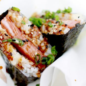 Spam musubi is a popular snack and lunch food in Hawaii composed of a slice of grilled Spam on top of a block of rice, wrapped together with nori dried seaweed in the tradition of Japanese omusubi.