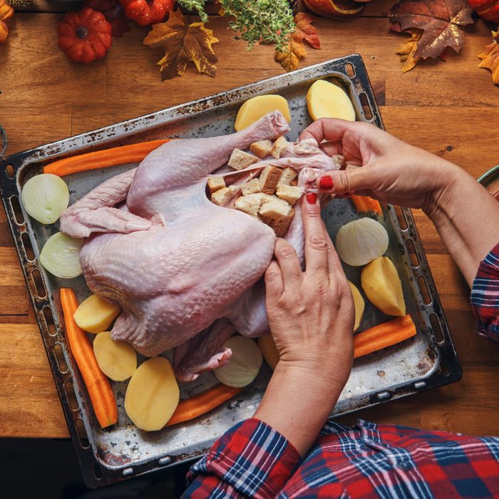 Preparing stuffed turkey with vegetables and other ingredients for holidays