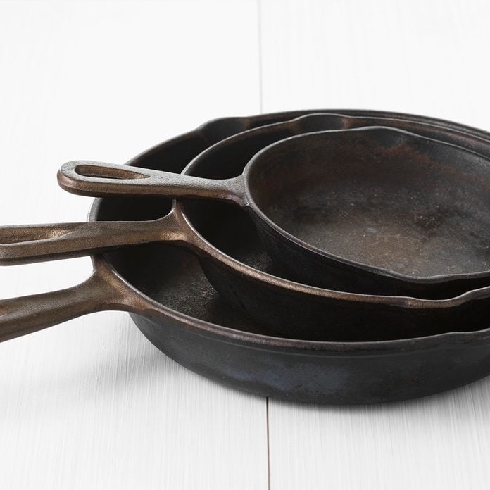 Three iron pans in different sizes