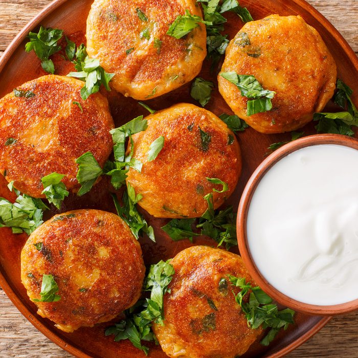 Aloo Tikki Potato Patty With Yogurt In Plate On Wooden Table