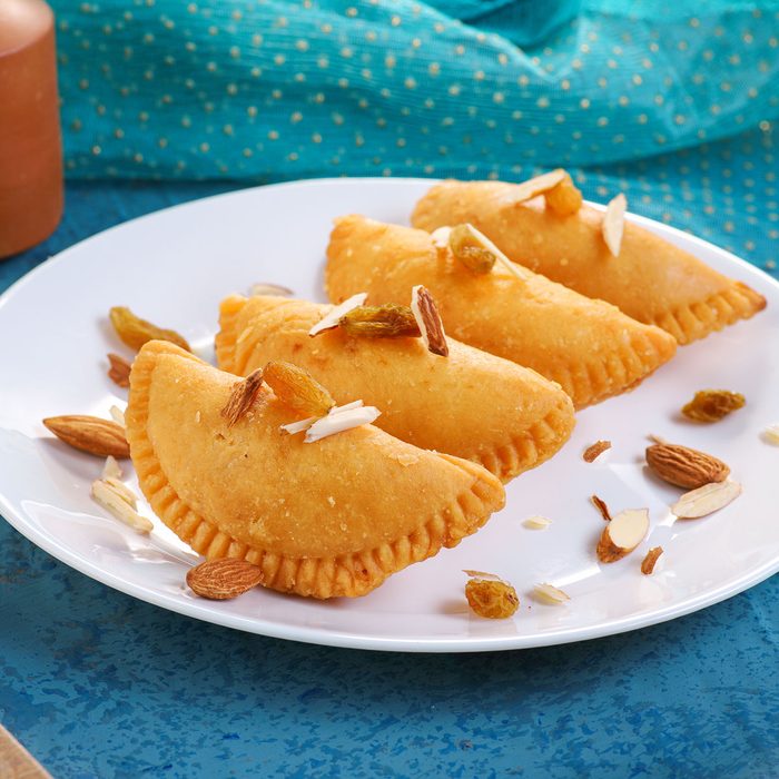 Gujiya Served In A Plate With Nuts
