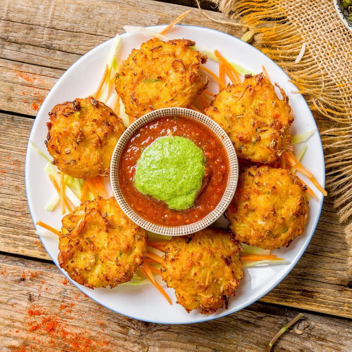 Mix Veg Pakora With Tomato Mint Sauce In Plate On Old Wooden Table