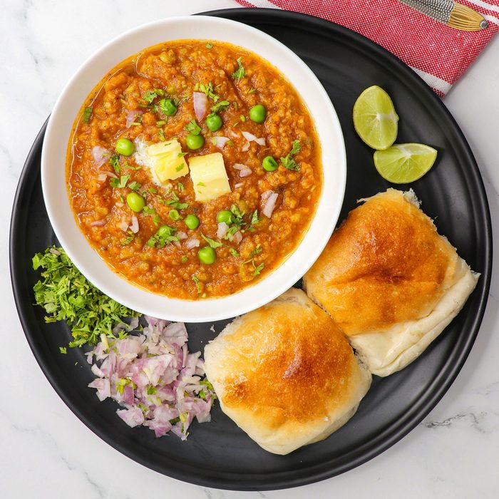 Pav Bhaji Served In A Black Plate On Marble Surface