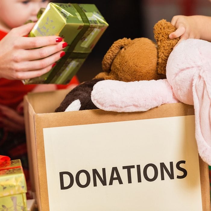 Family donating gifts and toys to charity for Christmas holiday