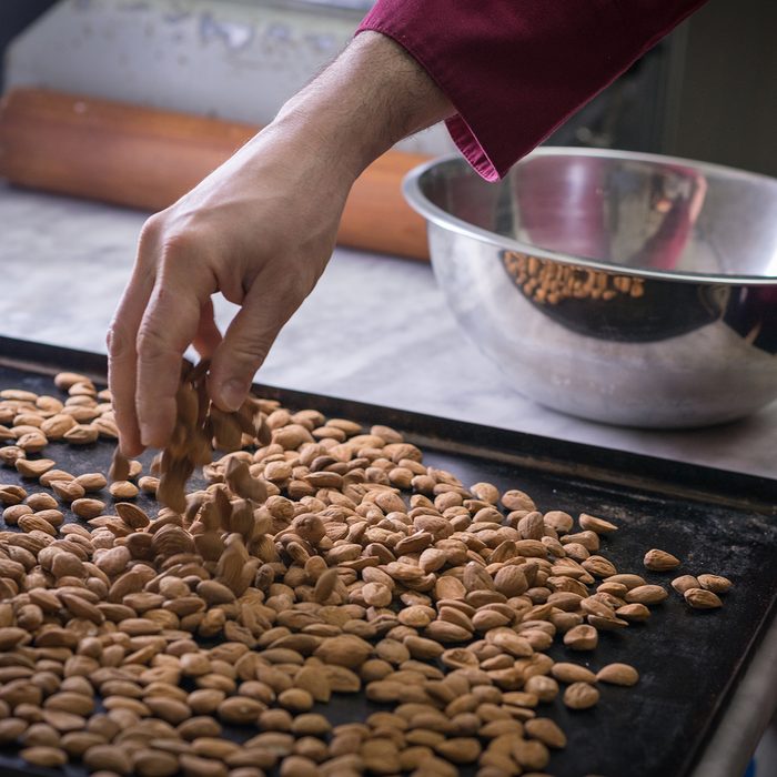 Italian pastry making patisserie baking confectioner: Toasting almonds on baking tray