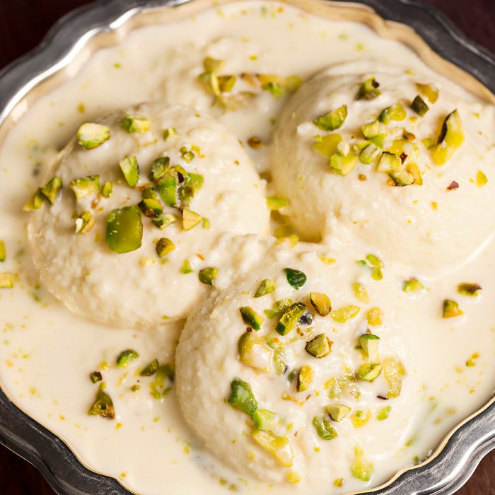 Rasmalai (or Ras Malai) is a Bengali dessert made from soft paneer cheese balls soaked in sweet milk which is flavored with saffron or cardamom. It is topped with chopped pistachio nuts.