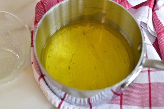 Clarified butter in a saucepan with solids at the bottom