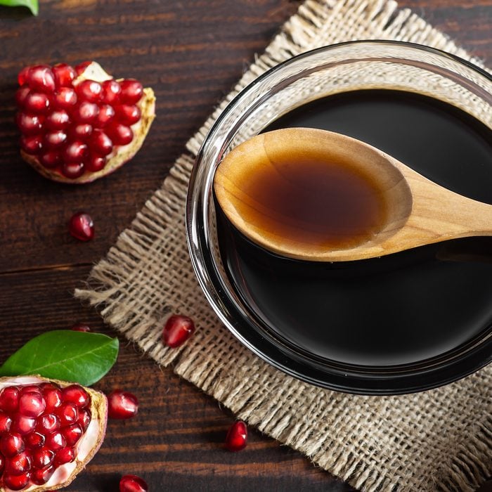 Pomegranate molasses in a glass bowl.