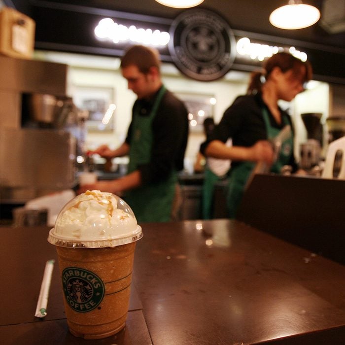 Seattle, UNITED STATES: Employees prepare beverages in the first Starbucks coffee shop in Seattle, 30 September 2006. Starbucks Corp. said it would raise most beverage prices at its US and Canadian coffee shops by five cents USD next month to help offset increased costs for fuel and labor. Starbucks opened its first location in Seattle's Pike Place Market in 1971. AFP PHOTO/GABRIEL BOUYS (Photo credit should read GABRIEL BOUYS/AFP via Getty Images)