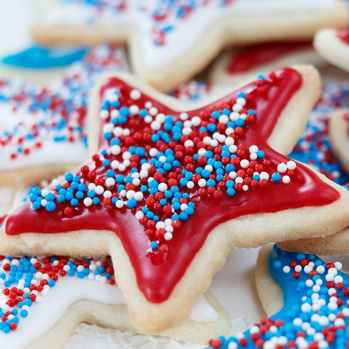Star sugar cookies decorated for 4th of July Independence day celebration in America. Icing and sprinkles in red, white, and blue.
