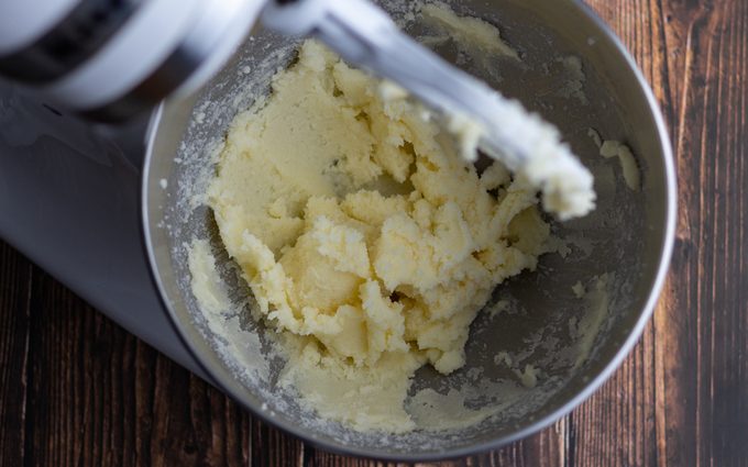 Bowl of stand mixer with blended butter mixture. how to cream butter and sugar
