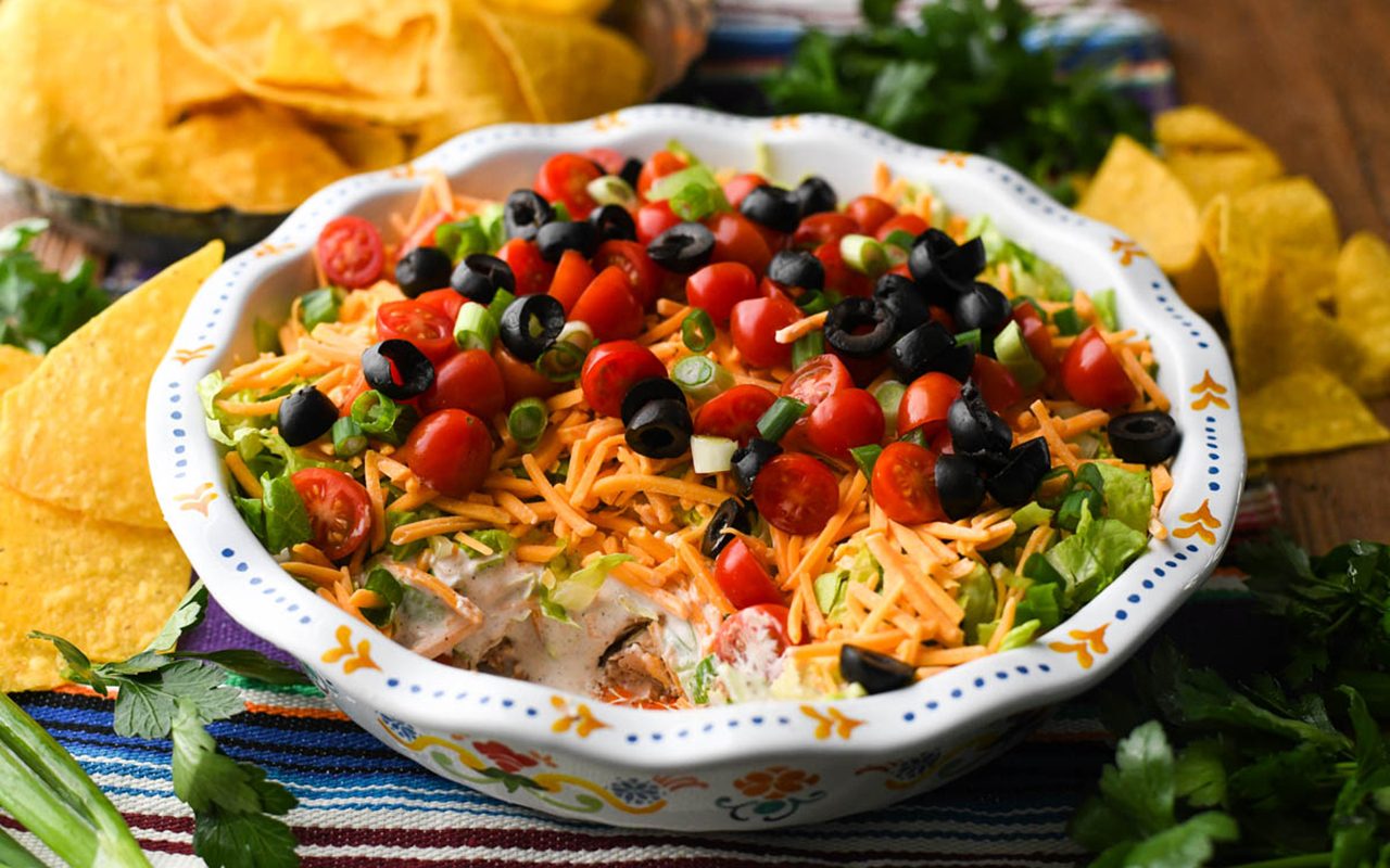 Serve the taco dip with tortilla chips and enjoy! how to make taco dip