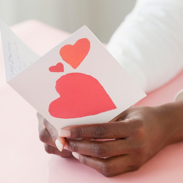 African Woman Holding Valentine's Day Card