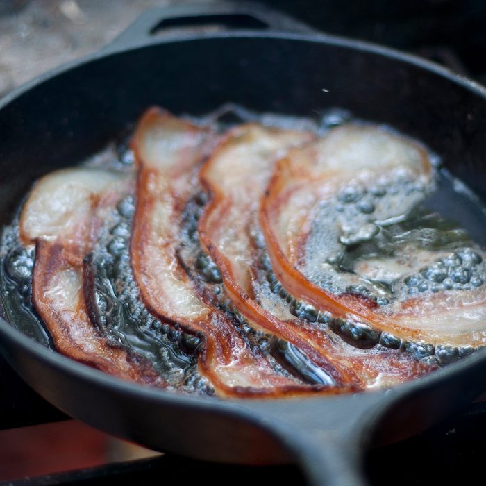 Close Up Of Bacon Frying In Pan