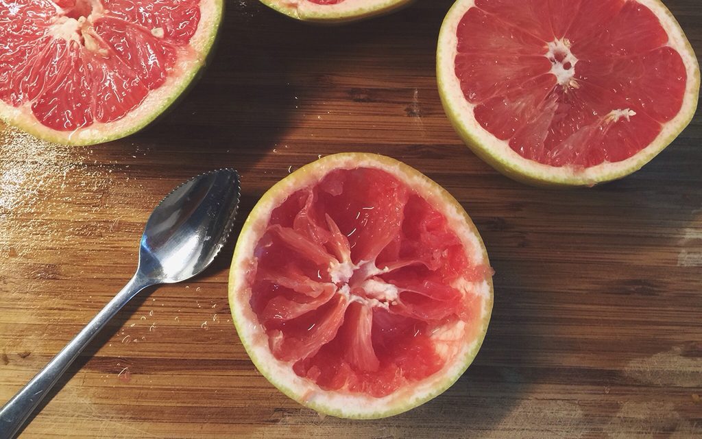 grapefruit spoon Halved Pink Grapefruit On Table