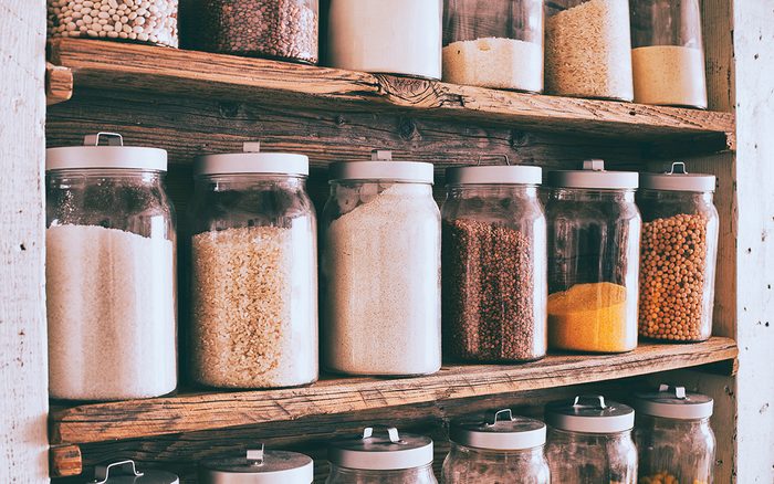 healthy pantry staples Jars Of Ingredients On Wooden Shelves