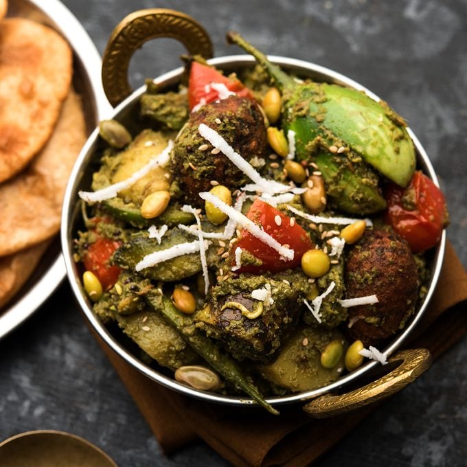 indian main dishes Undhiyu Is A Gujarati Mixed Vegetable Dish, Specialty Of Surat, India. Served In A Bowl With Or Without Poori