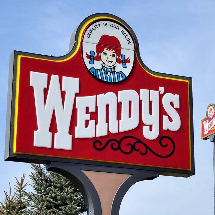 "Clio, Michigan, USA - March 7, 2012: The Wendy's location in Clio, Michigan. Founded in 1969 by Dave Thomas, Wendy's is a chain of fast food restaurants with over 6,600 locations in the US and abroad."