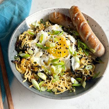breakfast ramen in a bowl with fried egg and sausage