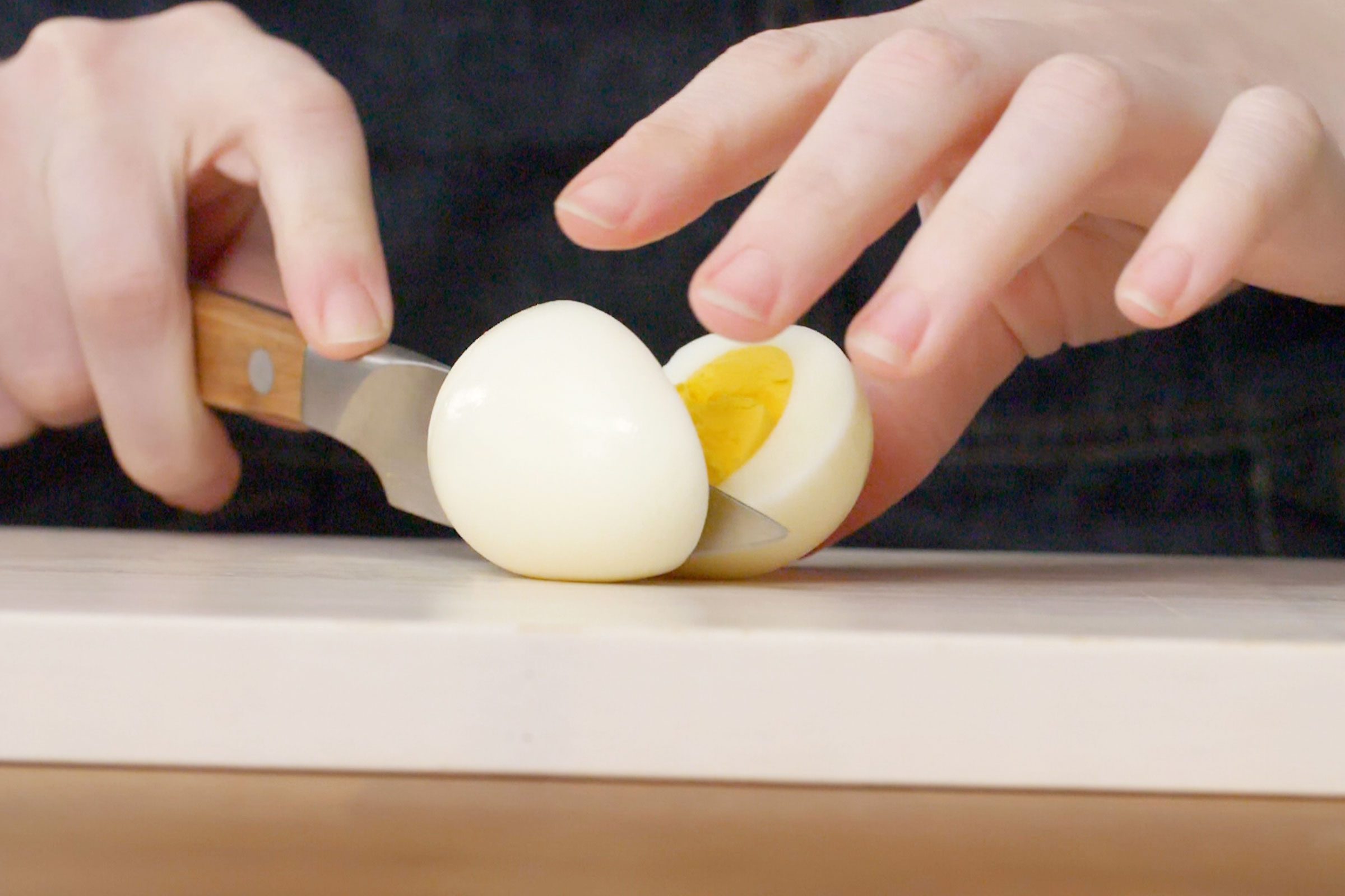 cutting a hard boiled egg in half