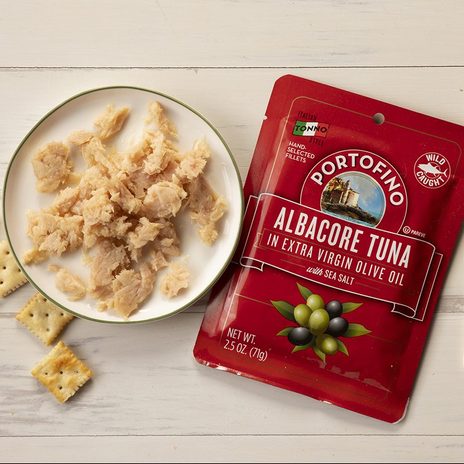Overhead Shot Of Portofino Tuna In Package And On Plate With Fork And Crackers