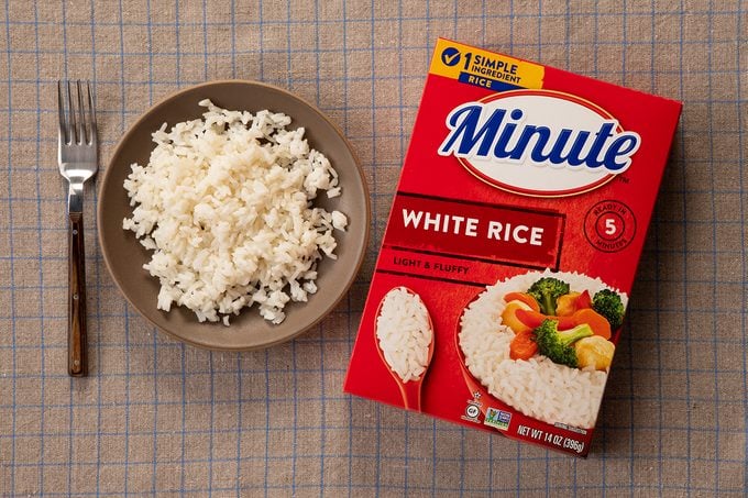 Overhead Shot Of Minute White Rice In Package And On Plate.