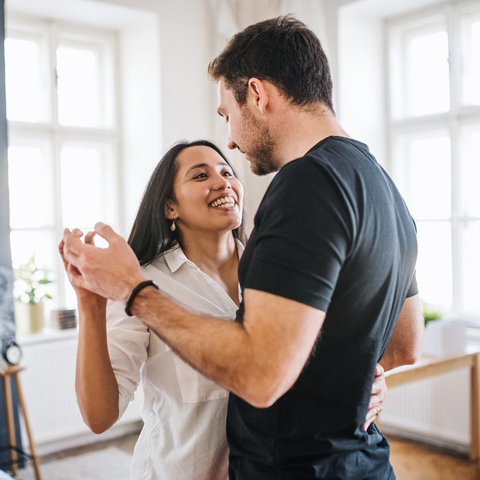 Affectionate Young Couple In Love Dancing At Home, Having Fun.