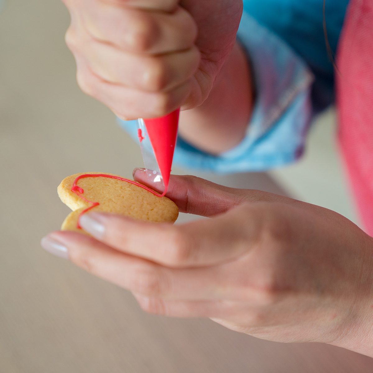 Close Up Of A Woman Icing A Cookie