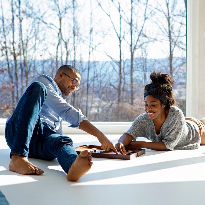 Couple Enjoying Backgammon Game At Home