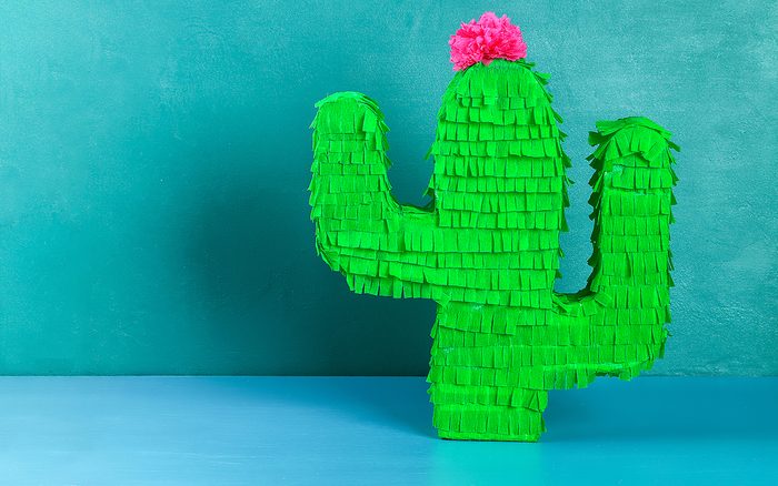 how to make a pinata Diy cinco de mayo Mexican Pinata Cactus made cardboard and crepe paper your own hands on a blue background. Gift idea, decor, game cinco de mayo. Step by step. Top view. Process kid children craft.