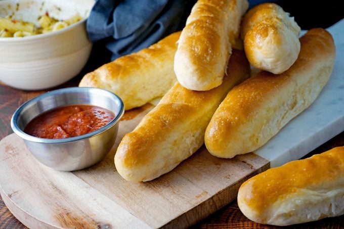 Finished Olive Garden Breadsticks with a side of sauce