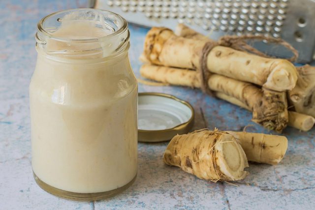 Fresh horseradish root and a small jar of prepared white horseradish, which can be used for Passover maror.