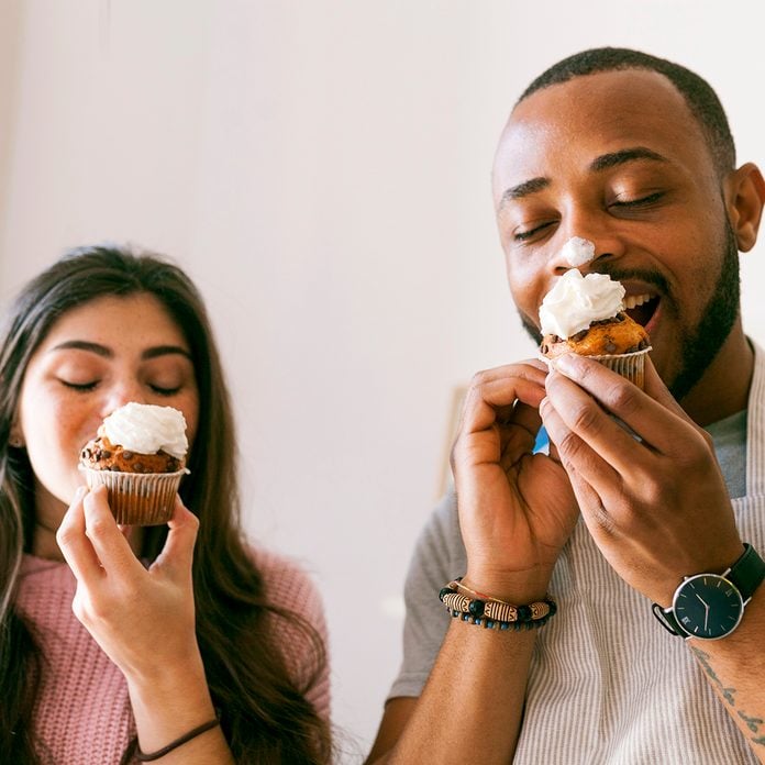 Young Couple Having Fun, Eating Fresh Cupcakes