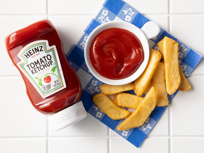 Overhead Shot Of Heinz Ketchup In Bottle With Fries.