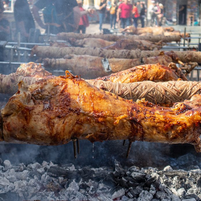 easter traditions around the world Greek Easter Custom. Kokoretsi, Kokorec And Lamb, Sheep, Kid Grilling On Spits Over Charcoals Fire.
