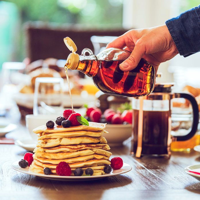 Stack of Pancakes with Maple Syrup, Berries and Fresh Coffee for breakfastStack of Pancakes with Maple Syrup, Berries and Fresh Coffee for breakfast