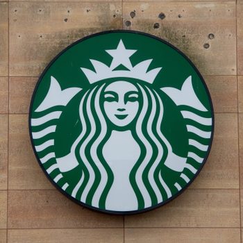 Starbucks logo Sign on wood paneled wall