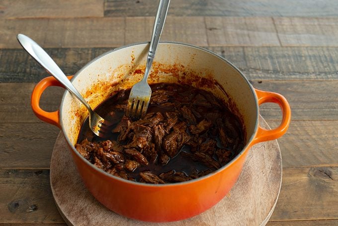 Shredding Beef birria tacos