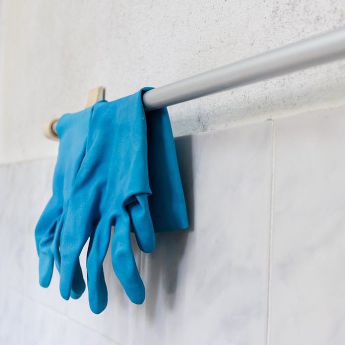 Blue Glove Hanging On Towel Rack In Bathroom