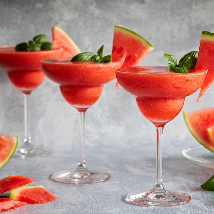 Frozen Red Drink Margarita Garnished With Watermelon And Basil. Three Red Drinks In A Row.