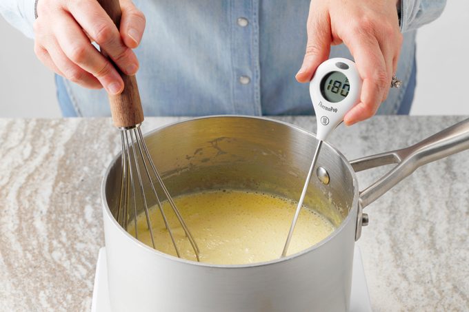 thermometer in pan cooking custard