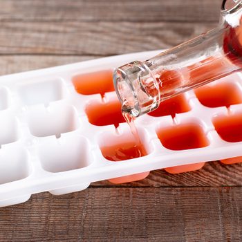 Pouring Wine In Ice Cube Tray On A Table