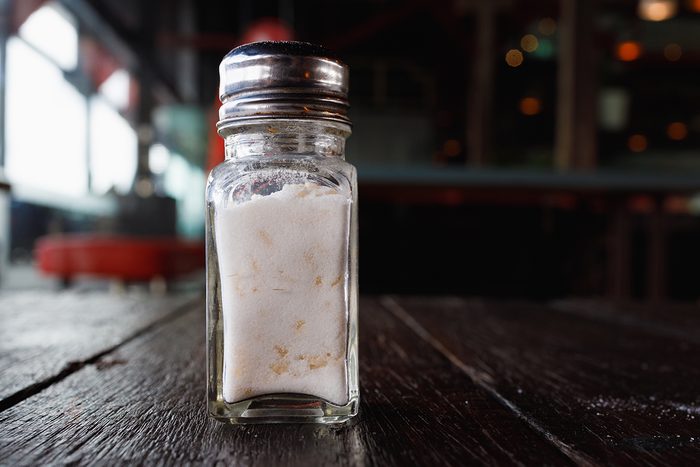Rice in Salt Shaker On A Wooden Table