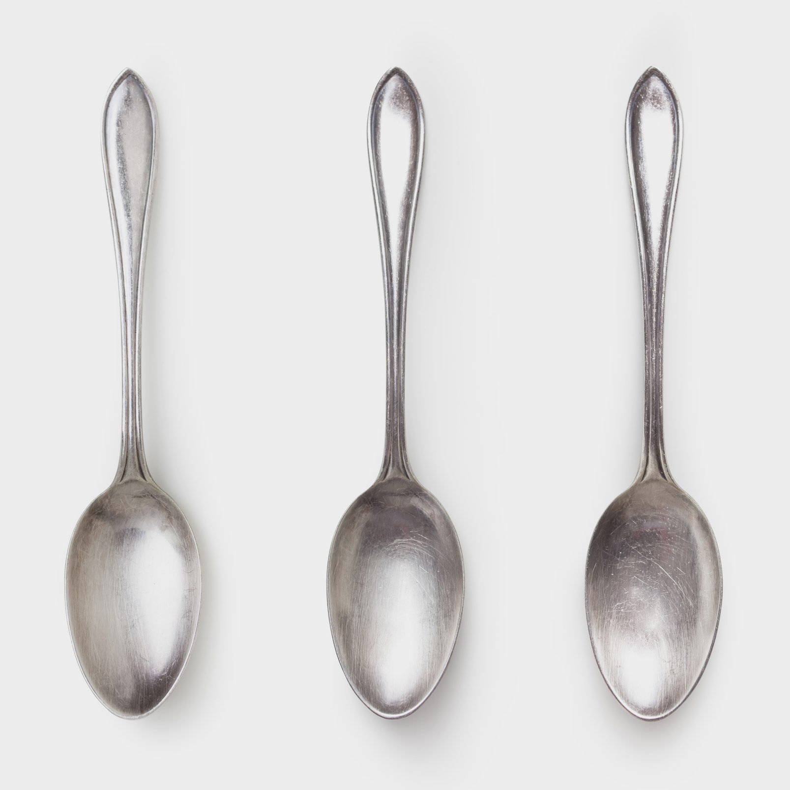 three spoons on white background shot from above